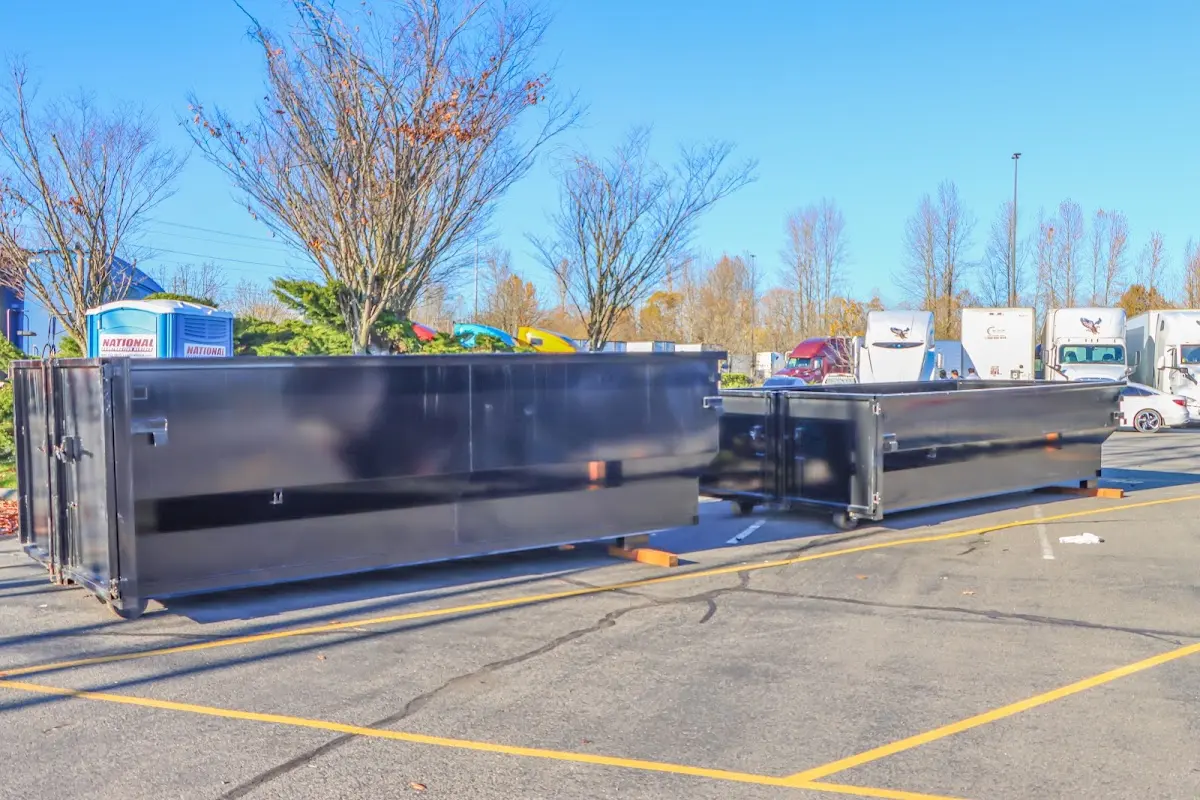 Professional dumpster rental service with roll-off container on residential driveway in McCandless